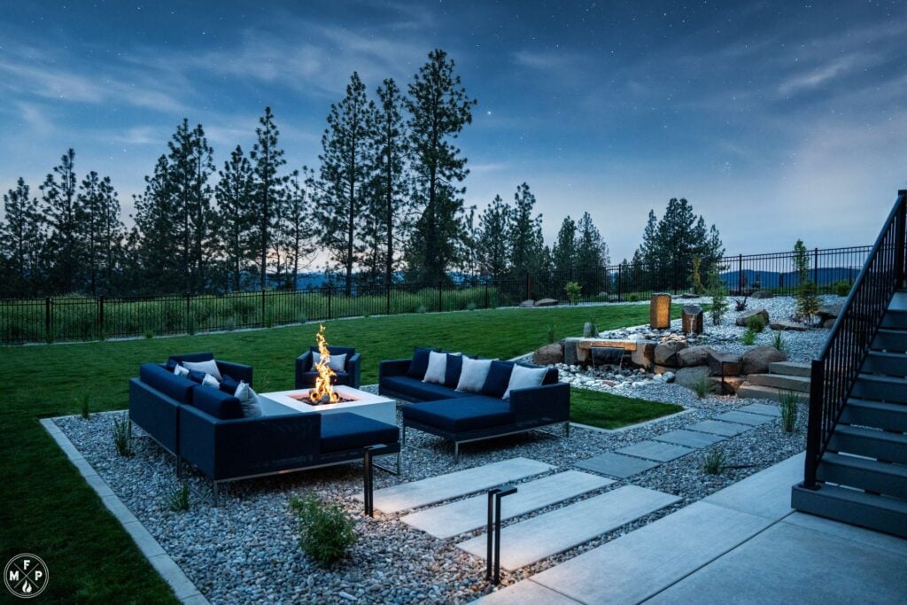 white fire pit with blue sofas and beautiful starry night sky