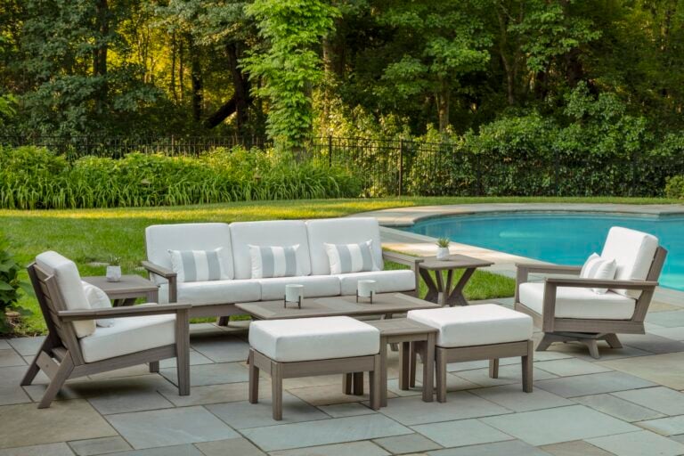 high-end furniture by Seaside Furniture called the DEX collection, with white cushions and teak frame near a swimming pool in the garden