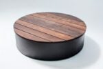 round wood fire pit cover raised to allow for fire media
