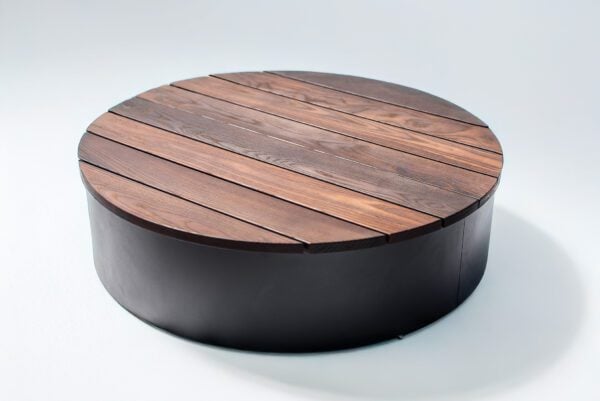 round wood fire pit cover raised to allow for fire media