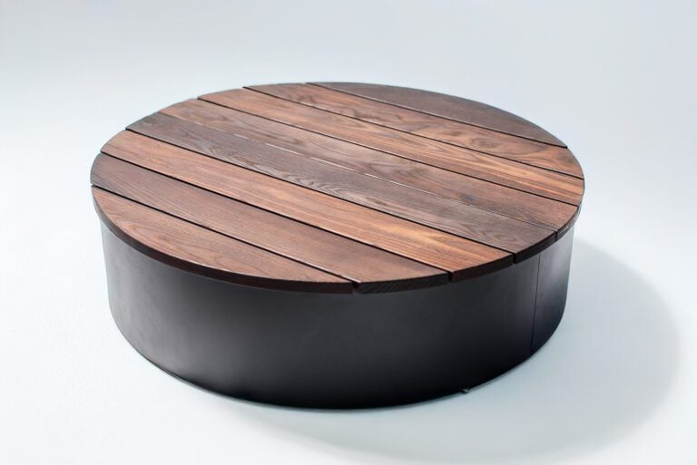 round wood fire pit cover raised to allow for fire media