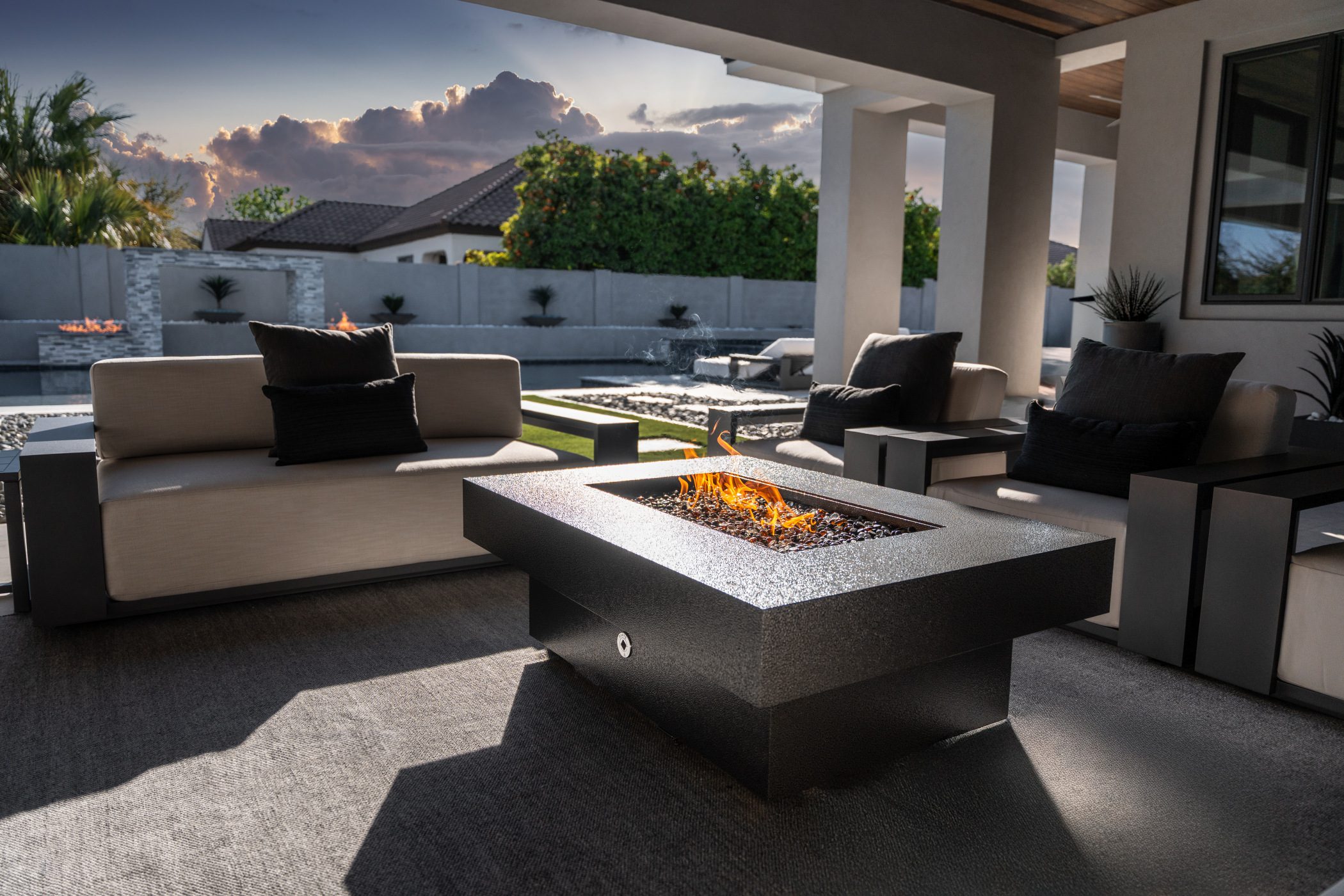 Close-up of a stainless steel smokeless fire pit with glowing flames in beautiful, relaxing backyard