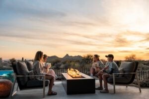 People unwinding by a modern fire pit, enjoying healthy reflection outdoors.