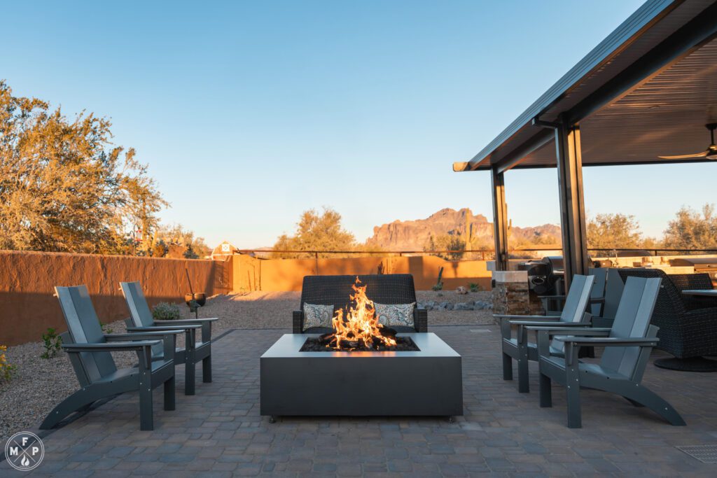Close-up of a stainless steel smokeless fire pit with glowing flames in a comforting backyard at dusk.